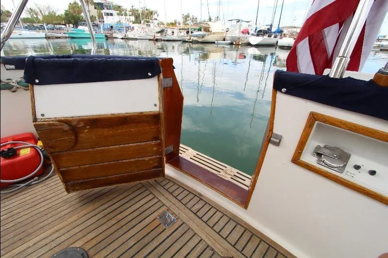 Yacht Photos Pics 1989 Grand Banks Classic yacht deck with open wooden door, marina view.