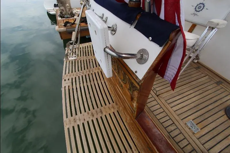  Yacht Photos Pics 1989 Grand Banks Classic yacht with wooden deck and American flag at dock.