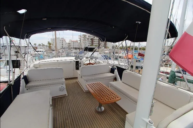  Yacht Photos Pics 1989 Grand Banks Classic yacht deck with seating and wooden table in marina.