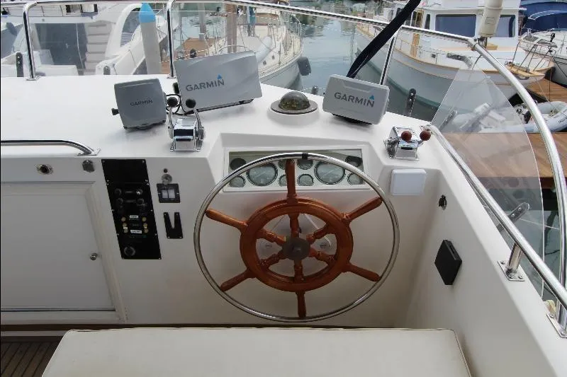  Yacht Photos Pics 1989 Grand Banks Classic helm with wooden wheel and Garmin navigation systems.