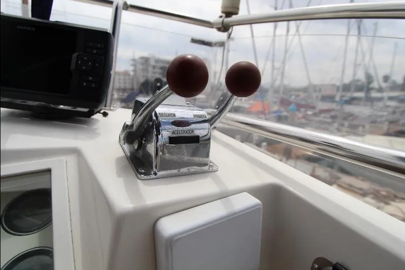  Yacht Photos Pics Control panel of a 1989 Grand Banks Classic boat with throttle levers and navigation equipment.