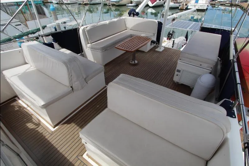  Yacht Photos Pics 1989 Grand Banks Classic yacht deck with white seating and wooden table.