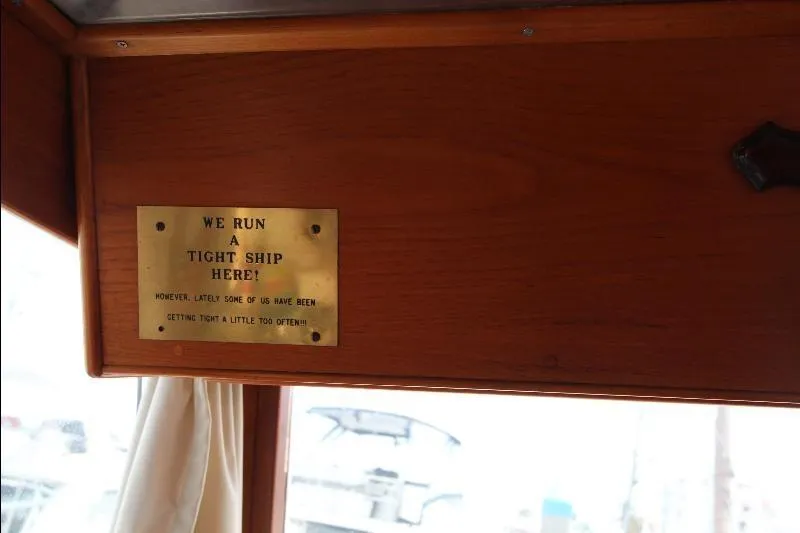  Yacht Photos Pics Plaque on 1989 Grand Banks Classic boat with humorous message about running a tight ship.