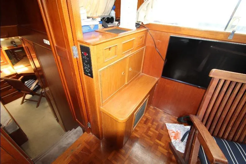  Yacht Photos Pics 1989 Grand Banks Classic interior with wooden cabinetry and seating area.