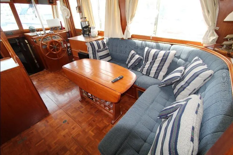  Yacht Photos Pics Interior of 1989 Grand Banks Classic yacht with cozy seating and wooden accents.