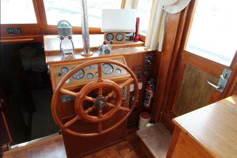  Yacht Photos Pics 1989 Grand Banks Classic helm with wooden wheel and navigation instruments.