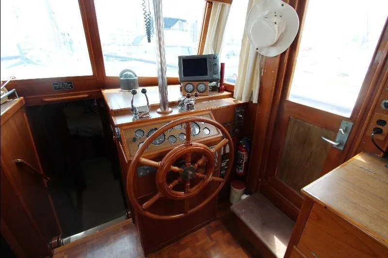  Yacht Photos Pics 1989 Grand Banks Classic boat helm with wooden wheel and navigation equipment.