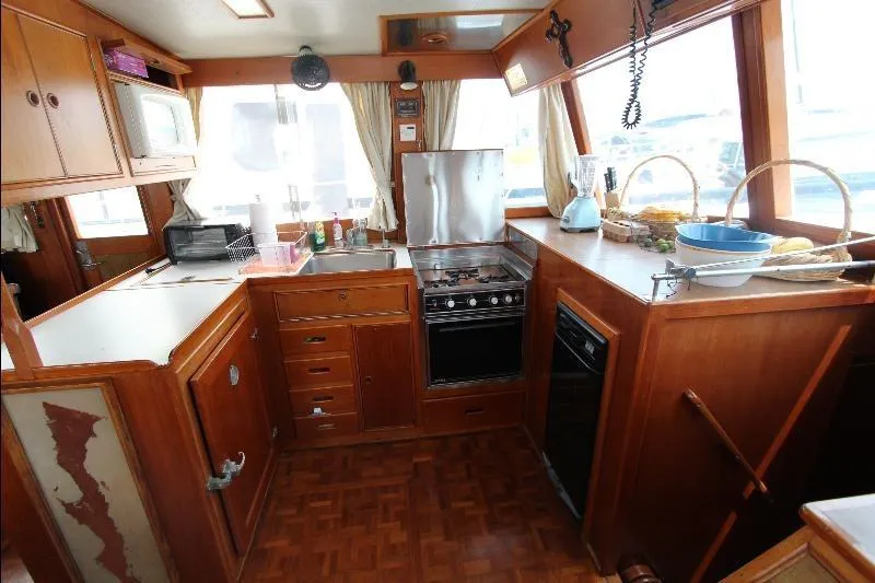  Yacht Photos Pics 1989 Grand Banks Classic yacht kitchen with wooden cabinetry and modern appliances.