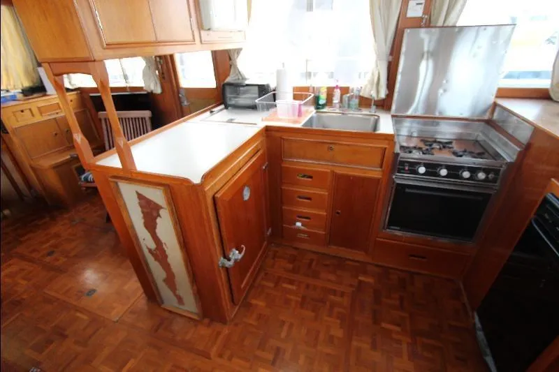  Yacht Photos Pics 1989 Grand Banks Classic yacht kitchen with wooden cabinetry and stainless steel appliances.