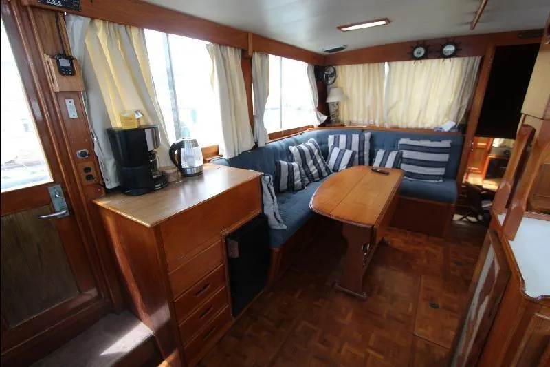  Yacht Photos Pics 1989 Grand Banks Classic yacht interior with cozy seating, wooden cabinetry, and nautical decor.