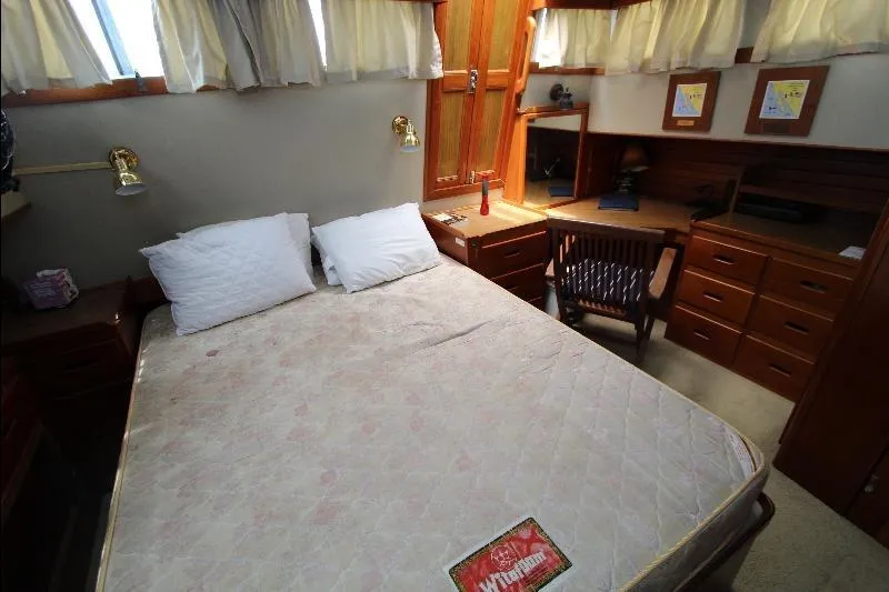  Yacht Photos Pics 1989 Grand Banks Classic cabin interior with bed, desk, and wooden furnishings.