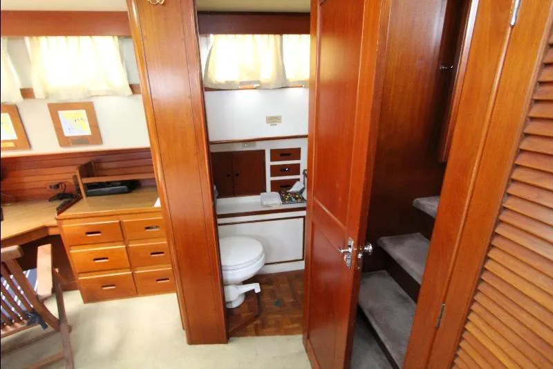  Yacht Photos Pics Interior of 1989 Grand Banks Classic yacht with wooden cabinetry and compact bathroom.