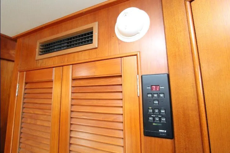  Yacht Photos Pics 1989 Grand Banks Classic interior with wooden paneling, vent, and control panel.