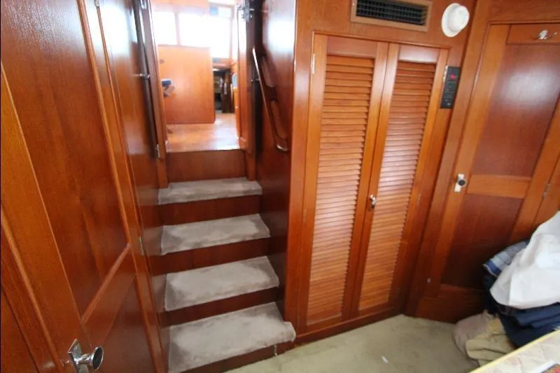 Yacht Photos Pics Interior of 1989 Grand Banks Classic yacht with wooden paneling and carpeted stairs.