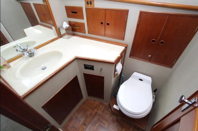  Yacht Photos Pics 1989 Grand Banks Classic yacht bathroom with wooden cabinets and white fixtures.