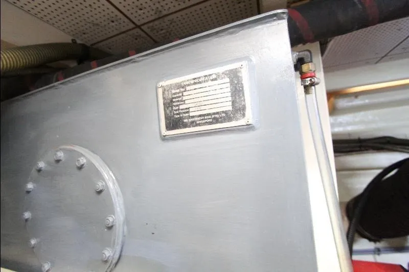  Yacht Photos Pics Engine room detail of 1989 Grand Banks Classic boat, featuring a metal tank with a label.