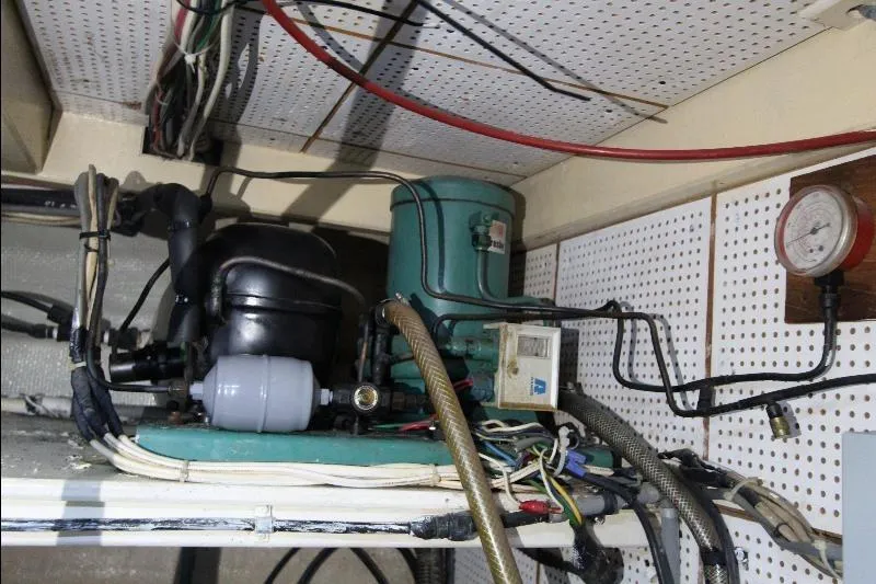  Yacht Photos Pics Engine room of a 1989 Grand Banks Classic boat with mechanical components and wiring.