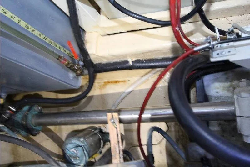  Yacht Photos Pics Engine compartment of a 1989 Grand Banks Classic boat, showcasing pipes and wiring.