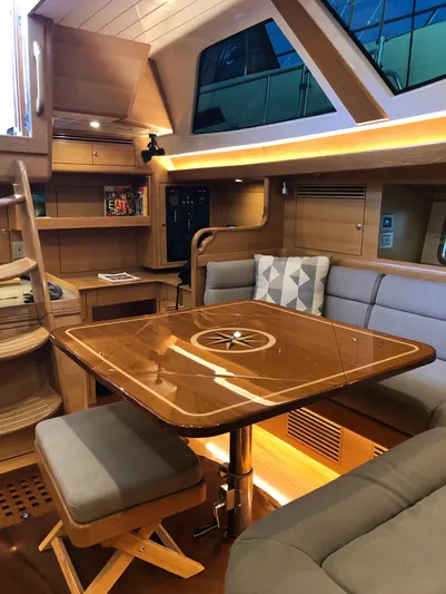 Pneumatic Yacht Photos Pics Luxurious interior of 2020 Outbound 56 yacht with elegant wood finishes and modern seating.