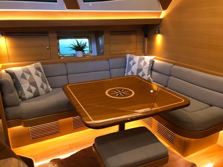 Pneumatic Yacht Photos Pics Luxurious interior of 2020 Outbound 56 yacht with cozy seating and elegant wooden table.