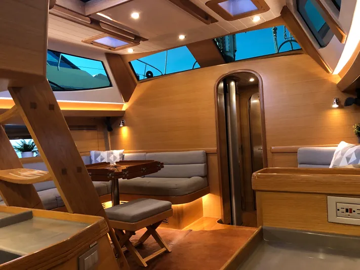 Pneumatic Yacht Photos Pics Luxurious interior of 2020 Outbound 56 yacht with modern wood finishes and ambient lighting.