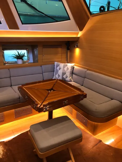 Pneumatic Yacht Photos Pics Luxurious interior of 2020 Outbound 56 yacht with cozy seating and elegant wooden table.
