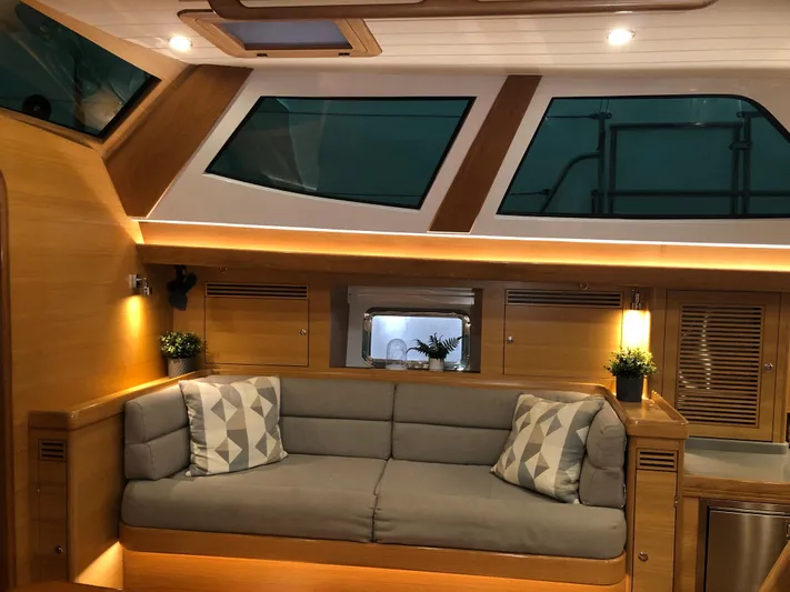 Pneumatic Yacht Photos Pics Luxurious interior of 2020 Outbound 56 yacht with modern seating and ambient lighting.