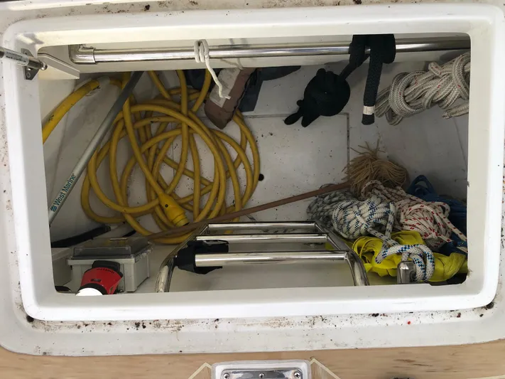 Pneumatic Yacht Photos Pics Storage compartment of 2020 Outbound 56 boat with ropes, ladder, and yellow hose.