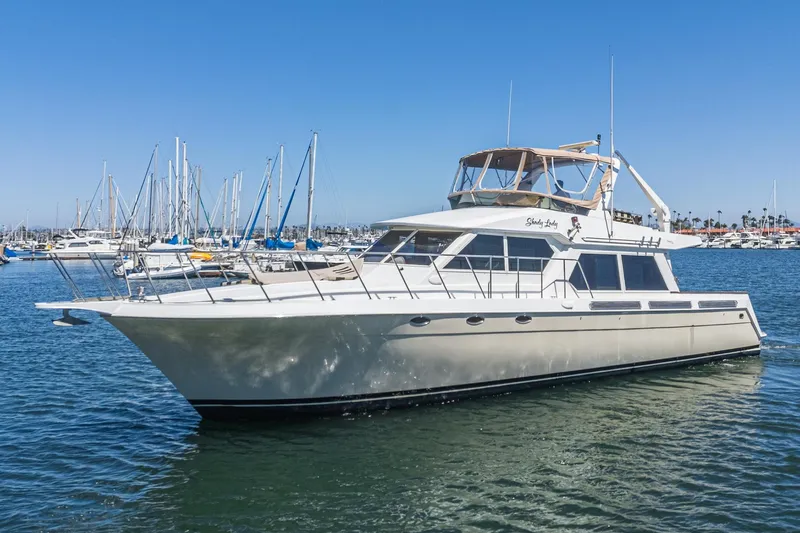 Shady Lady Yacht Photos Pics 1995 Navigator Classic yacht docked in a marina under clear blue skies.