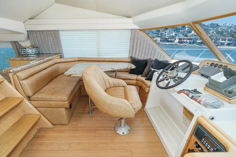 Shady Lady Yacht Photos Pics Interior of 1995 Navigator Classic yacht with leather seating and helm, overlooking waterfront.