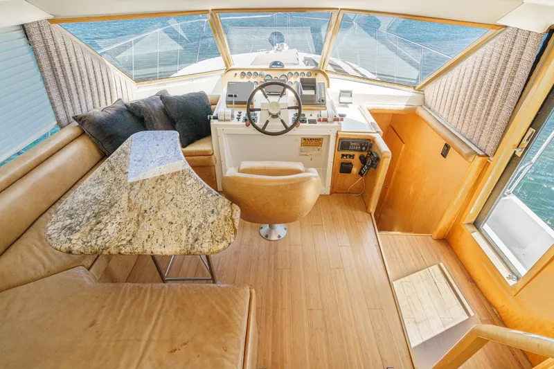 Shady Lady Yacht Photos Pics 1995 Navigator Classic yacht interior with helm, granite table, and leather seating.