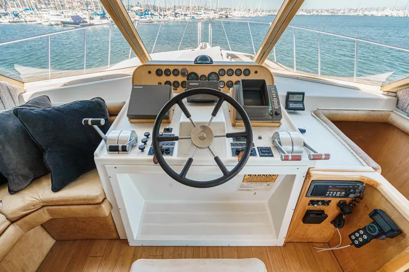 Shady Lady Yacht Photos Pics Helm of 1995 Navigator Classic yacht with steering wheel, controls, and ocean view.