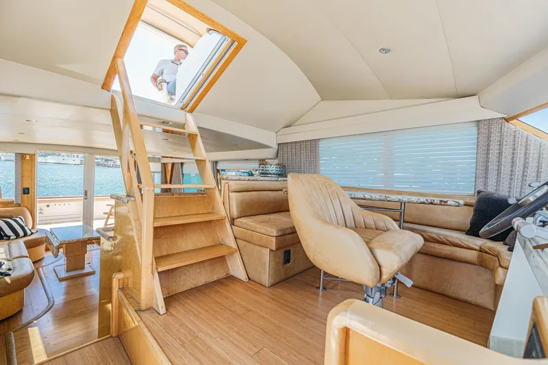 Shady Lady Yacht Photos Pics Interior of a 1995 Navigator Classic yacht with wooden stairs and leather seating.