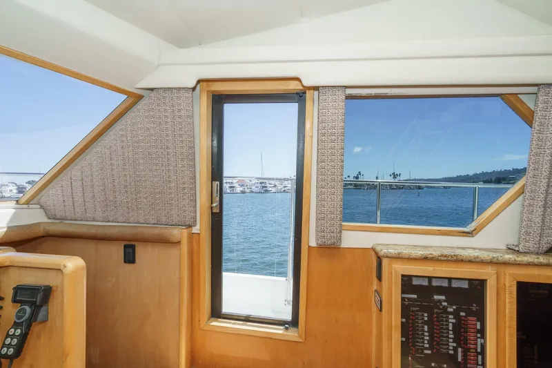 Shady Lady Yacht Photos Pics Interior view of 1995 Navigator Classic yacht with ocean and marina backdrop.