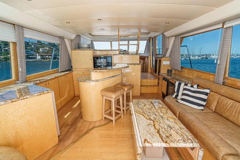 Shady Lady Yacht Photos Pics Luxurious 1995 Navigator Classic yacht interior with elegant wood and granite finishes, overlooking marina.