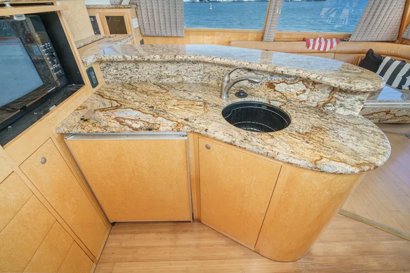 Shady Lady Yacht Photos Pics Luxurious yacht kitchen with granite countertops, sink, and wooden cabinetry, Navigator Classic 1995 model.