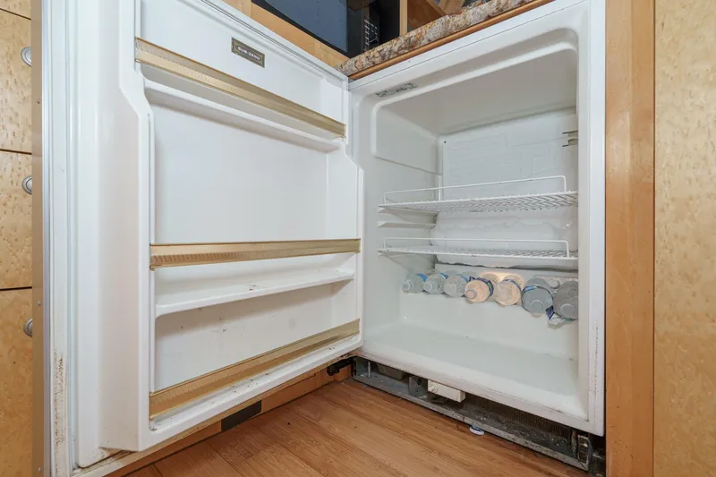 Shady Lady Yacht Photos Pics Open refrigerator in 1995 Navigator Classic RV, stocked with bottled water.