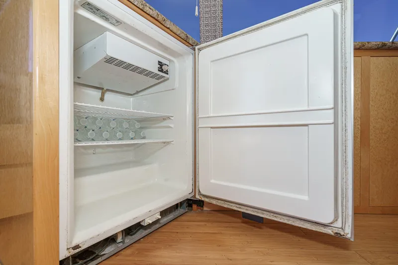 Shady Lady Yacht Photos Pics Open refrigerator with water bottles inside, Navigator Classic 1995 model.