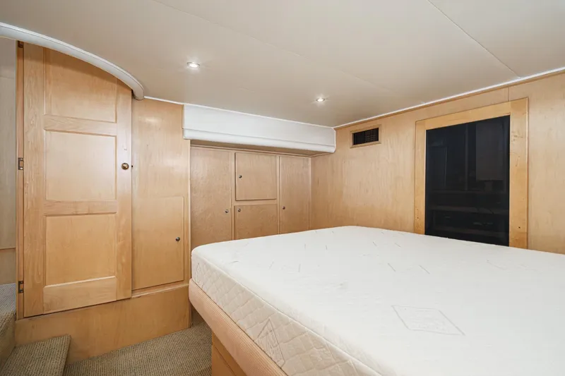 Shady Lady Yacht Photos Pics Cozy bedroom interior in 1995 Navigator Classic yacht with wooden cabinetry and comfortable bed.