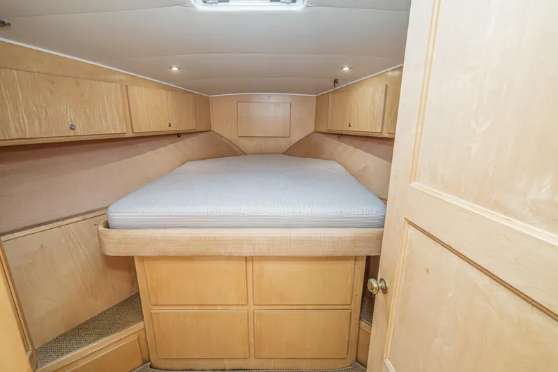 Shady Lady Yacht Photos Pics Cozy cabin interior of 1995 Navigator Classic yacht with wooden cabinetry and bed.