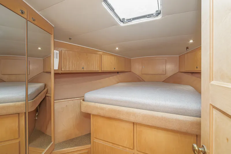 Shady Lady Yacht Photos Pics Cozy cabin interior of 1995 Navigator Classic yacht with mirrored closet and overhead storage.