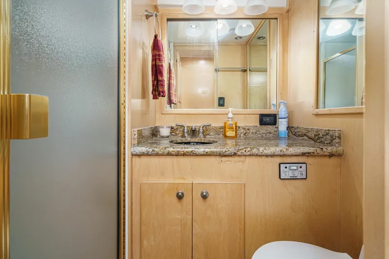 Shady Lady Yacht Photos Pics Luxurious 1995 Navigator Classic bathroom with granite countertop and modern fixtures.