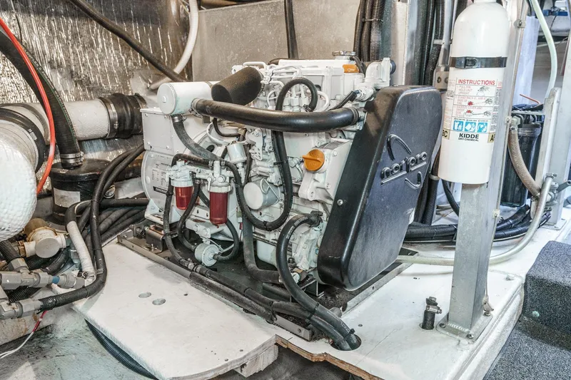 Shady Lady Yacht Photos Pics Engine room of a 1995 Navigator Classic yacht, featuring mechanical components and a fire extinguisher.