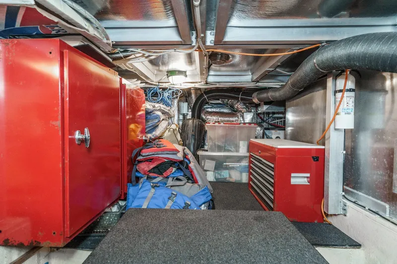 Shady Lady Yacht Photos Pics Interior of 1995 Navigator Classic with red cabinets, toolboxes, and storage bags.