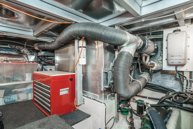 Shady Lady Yacht Photos Pics Engine room of a 1995 Navigator Classic yacht with red tool chest and ventilation pipes.