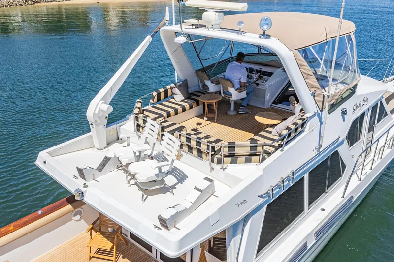 Shady Lady Yacht Photos Pics Luxury 1995 Navigator Classic yacht with spacious deck and seating, cruising on calm waters.