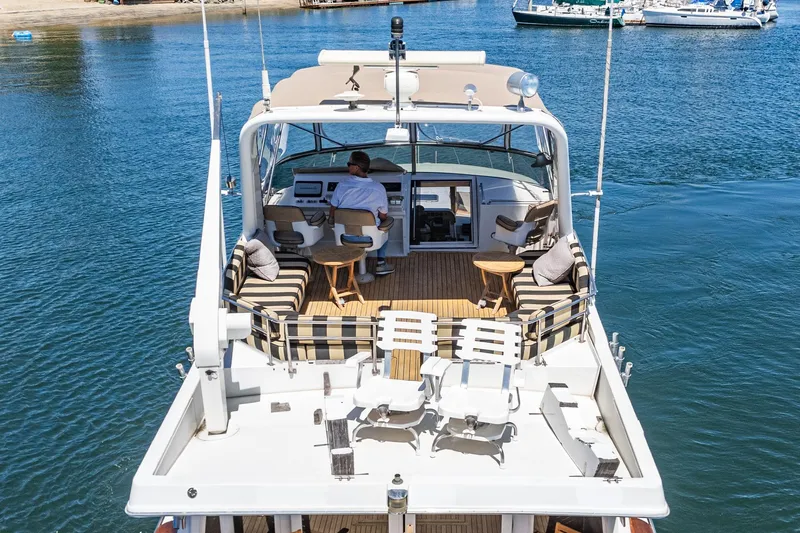 Shady Lady Yacht Photos Pics 1995 Navigator Classic yacht on water, featuring spacious deck and seating area.