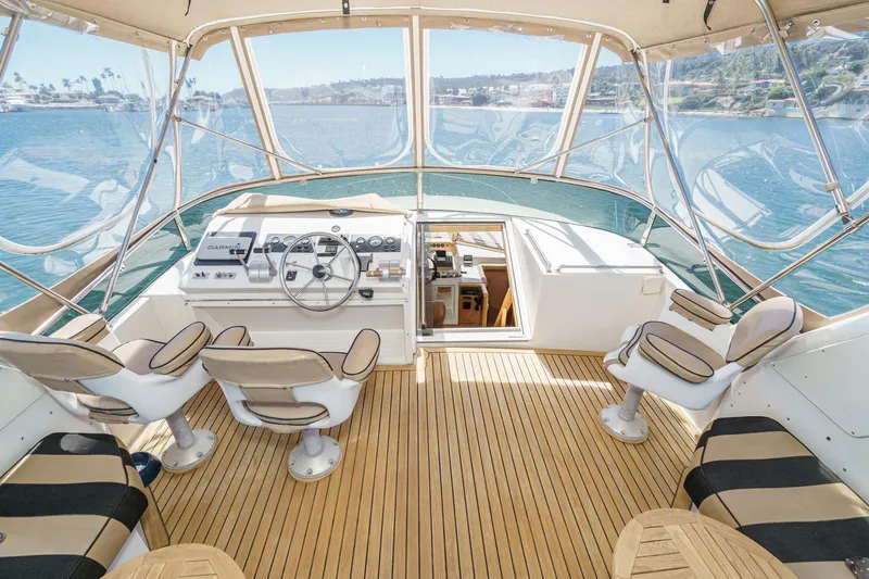 Shady Lady Yacht Photos Pics 1995 Navigator Classic yacht helm with seating, overlooking serene waters and clear skies.