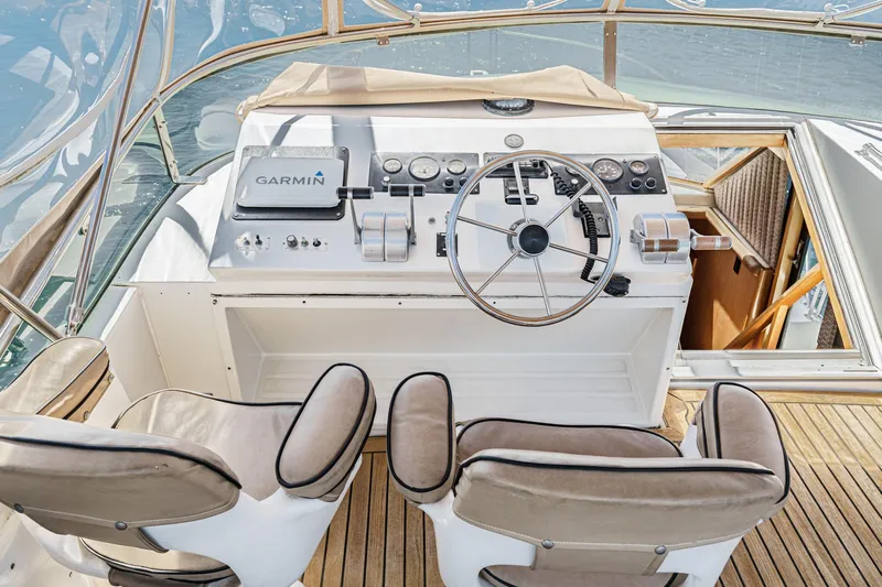 Shady Lady Yacht Photos Pics 1995 Navigator Classic yacht helm with Garmin navigation, featuring dual seats and wooden deck.
