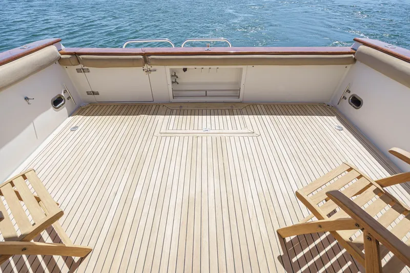 Shady Lady Yacht Photos Pics Spacious deck of 1995 Navigator Classic yacht with wooden chairs and ocean view.